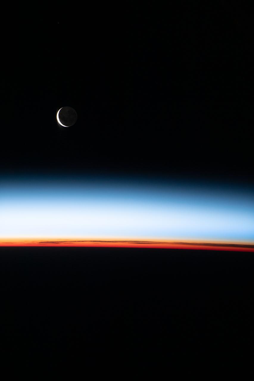 iss066e086973 (Dec. 6, 2021) --- A waxing crescent Moon is pictured from the International Space Station during an orbital sunset as it flew 268 miles above the Pacific Ocean east of New Zealand.