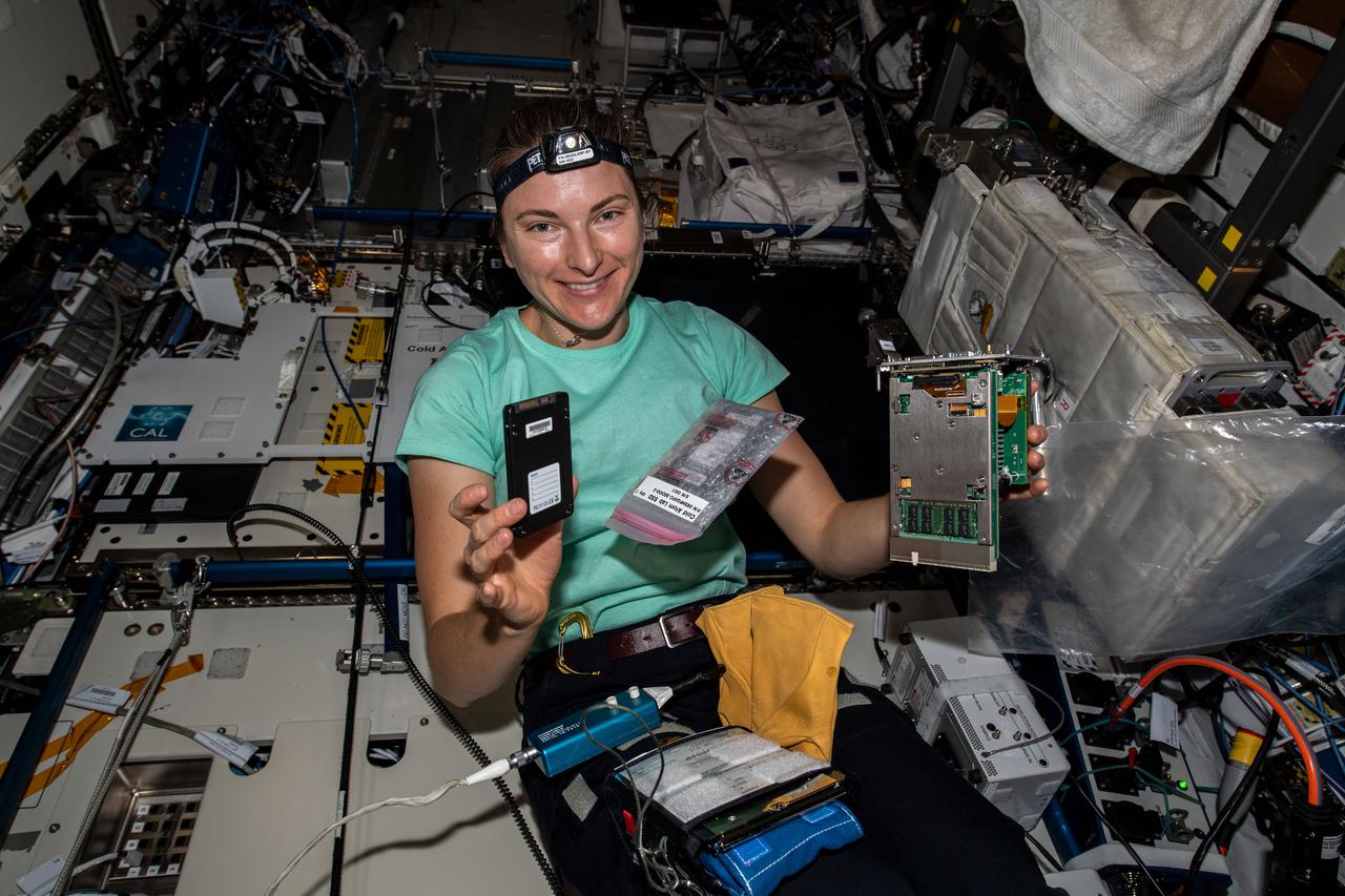 iss066e091400 (Dec. 16, 2021) --- NASA astronaut and Expedition 66 Flight Engineer Kayla Barron replaces computer hardware inside the International Space Station's Cold Atom Lab. The space physics device enables observations of atoms chilled to temperatures near absolute zero allowing scientists to study fundamental behaviors and quantum characteristics not possible on Earth.