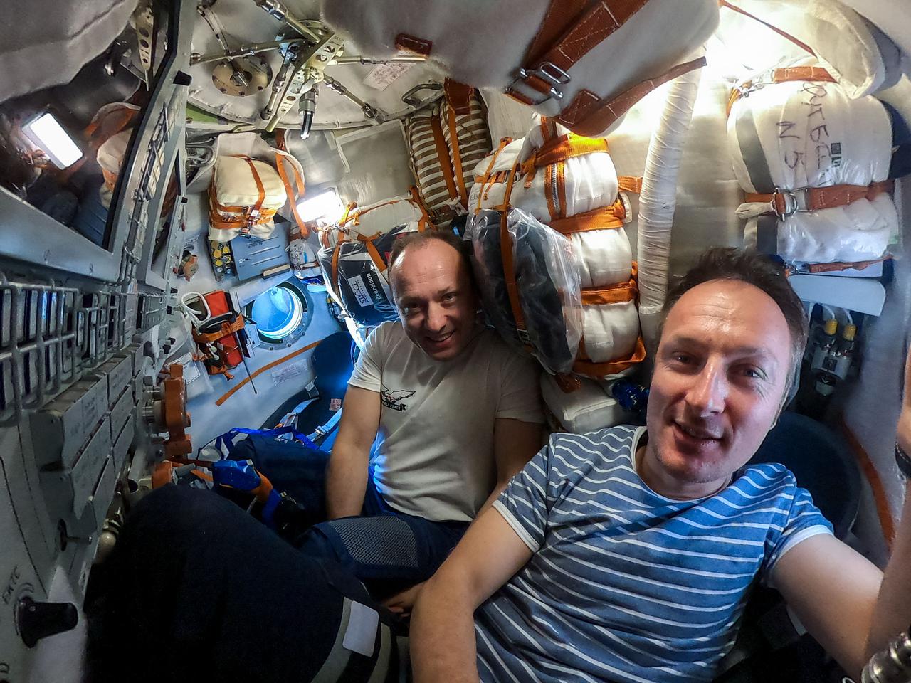 iss066e097125 (Dec. 19, 2021) --- Roscosmos cosmonaut Alexander Misurkin and ESA (European Space Agency) astronaut Matthias Maurer are pictured inside the Soyuz MS-20 crew ship. Misurkin would later undock in the Soyuz vehicle and depart from the International Space Station with spaceflight participants (not shown) Yusaku Maezawa and Yozo Hirano.