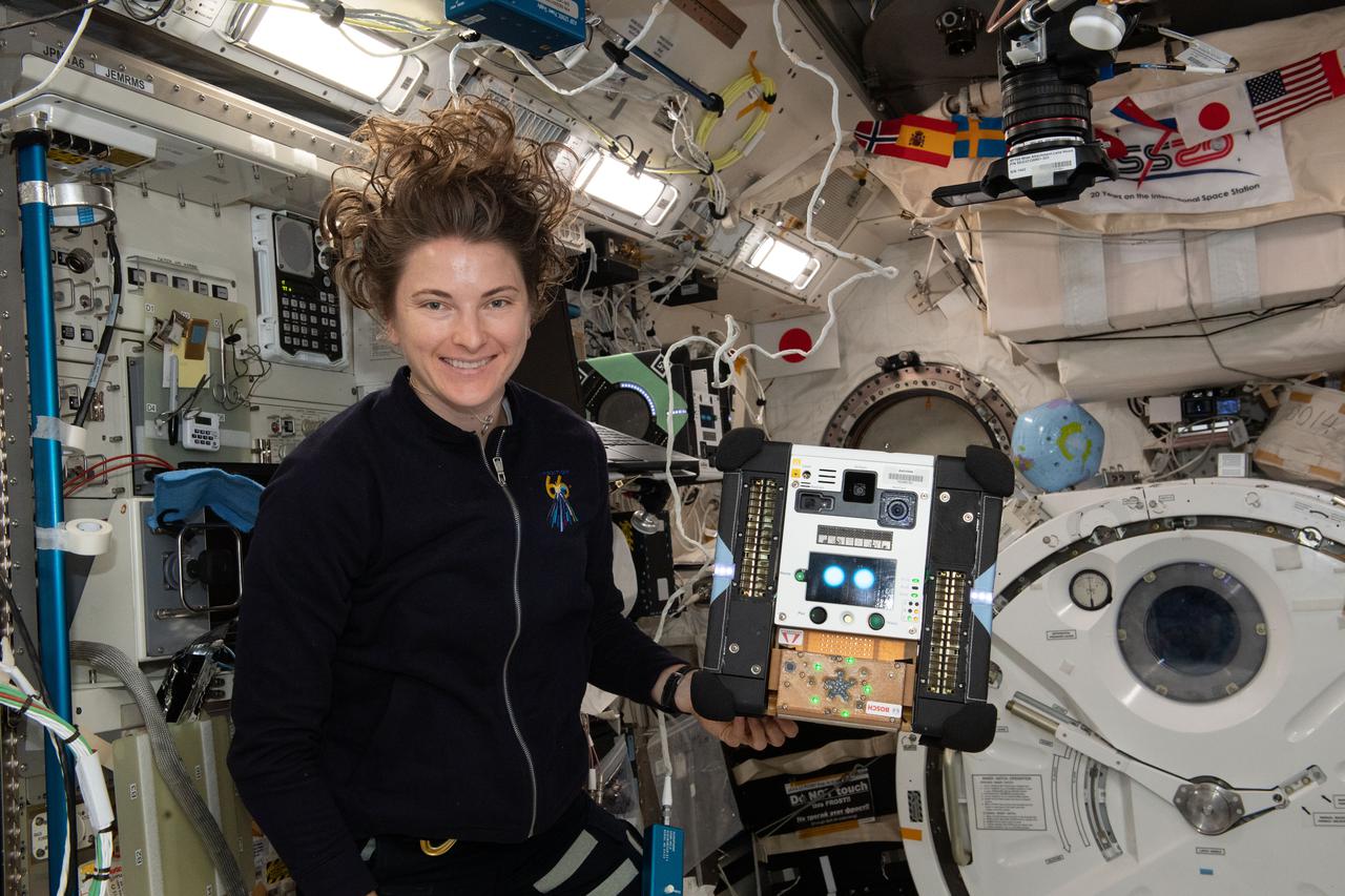 iss066e103488 (Jan. 3, 2022) --- NASA astronaut and Expedition 66 Flight Engineer Kayla Barron sets up an AstroBee robotic free flyer with an experimental audio sensor for the SoundSee Mission experiment. The robotics study uses acoustic technology to detect anomalies and possibly identify early indications of space hardware failure.