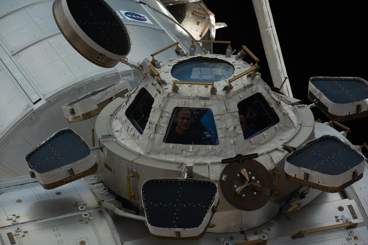 iss066e109471 (Jan. 7, 2022) --- NASA astronaut and Expedition 66 Flight Engineer Thomas Marshburn peers out from a window inside the cupola, the International Space Station's "window to the world."