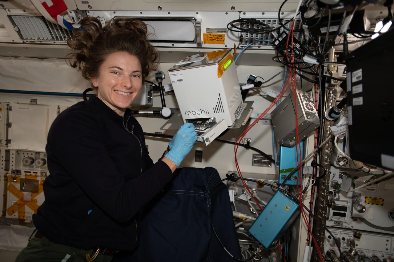iss066e110569 (Jan. 10, 2022) --- NASA astronaut and Expedition 66 Flight Engineer Kayla Barron sets up and installs the Mochii electron-scanning microscope that can be used to identify trace particles aboard the International Space Station.