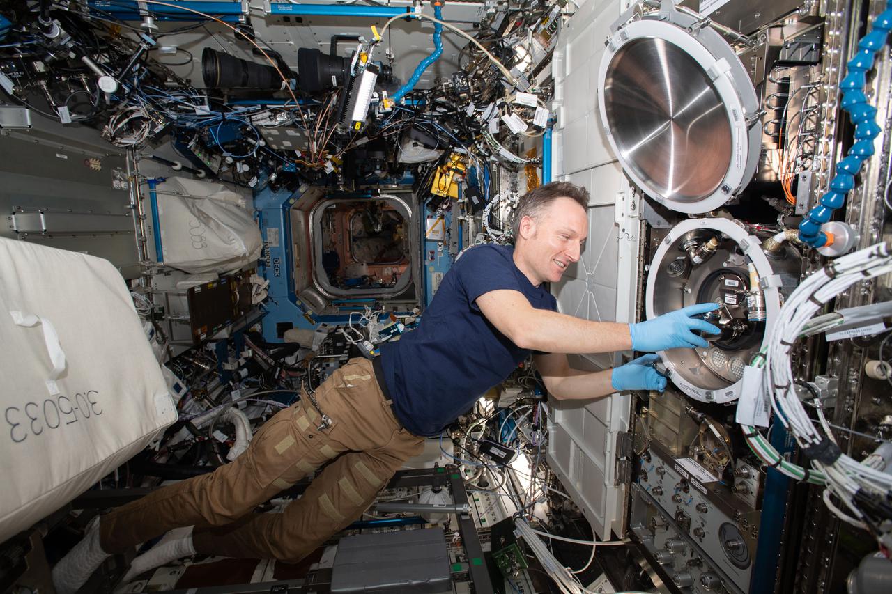 iss066e114140 (Jan. 12, 2022) --- ESA (European Space Agency) astronaut and Expedition 66 Flight Engineer Matthias Maurer swaps samples inside the Materials Science Laboratory, a physics research device that observes metals, alloys, polymers, semiconductors, ceramics, crystals, and glasses, to discover new applications for existing materials and new or improved materials.