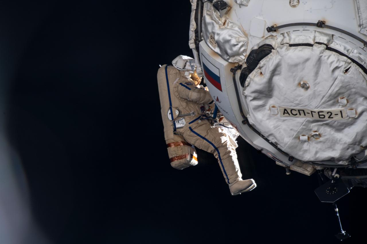iss066e122069 (Jan. 19, 2022) --- Cosmonaut Pyotr Dubrov works to configure and activate the Prichal docking module with the Russian segment of the International Space Station during a seven-hour and 11-minute spacewalk.