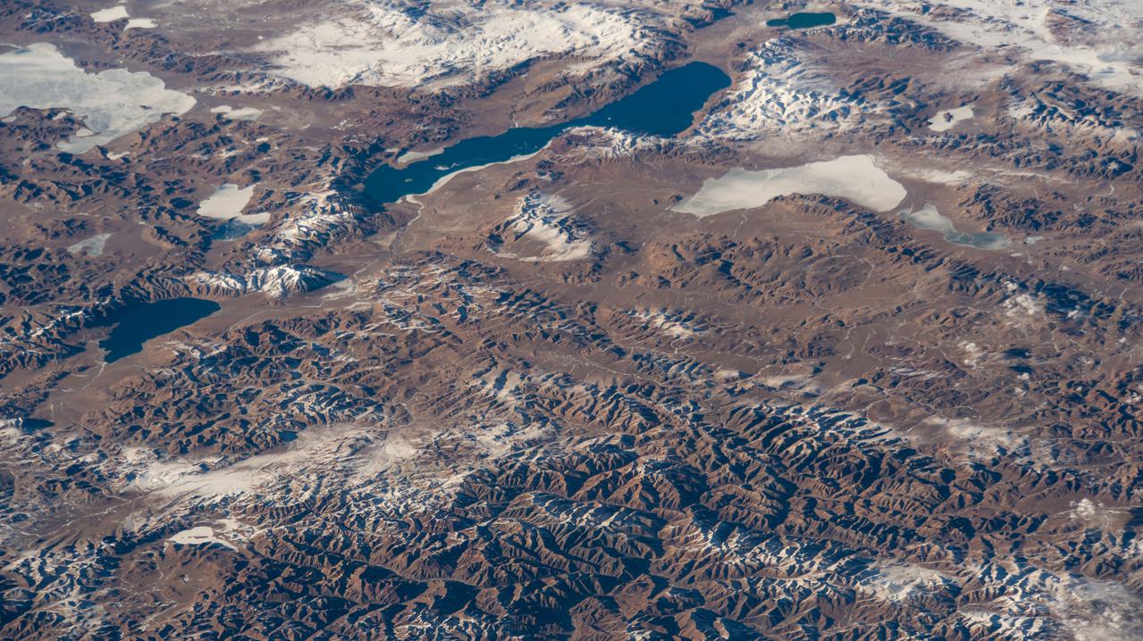 iss066e123378 (Jan. 21, 2022) --- Xuru Co and Deng Reyongcuo, two lakes in southern China just north of the Himalayas, are pictured in this oblique image from the International Space Station as it orbited 257 miles above Bangladesh.