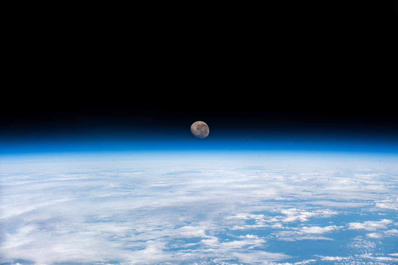 iss066e124140 ​(Jan. 21, 2022) --- The waning gibbous Moon is pictured above the Earth's horizon as the International Space Station orbited 272 miles above the Atlantic Ocean in bnetween the tips of South America and South Africa.