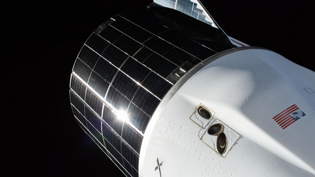 iss066e125326 (Jan. 22, 2022) --- The SpaceX Cargo Dragon resupply ship, with its white pressurized capsule and dark solar panel-covered, unpressurized trunk, is pictured moments before undocking from the Harmony module's space-facing port on the International Space Station. Also seen on the capsule, are a set of Draco engines that help the spacecraft maneuver and orient itself in orbit.