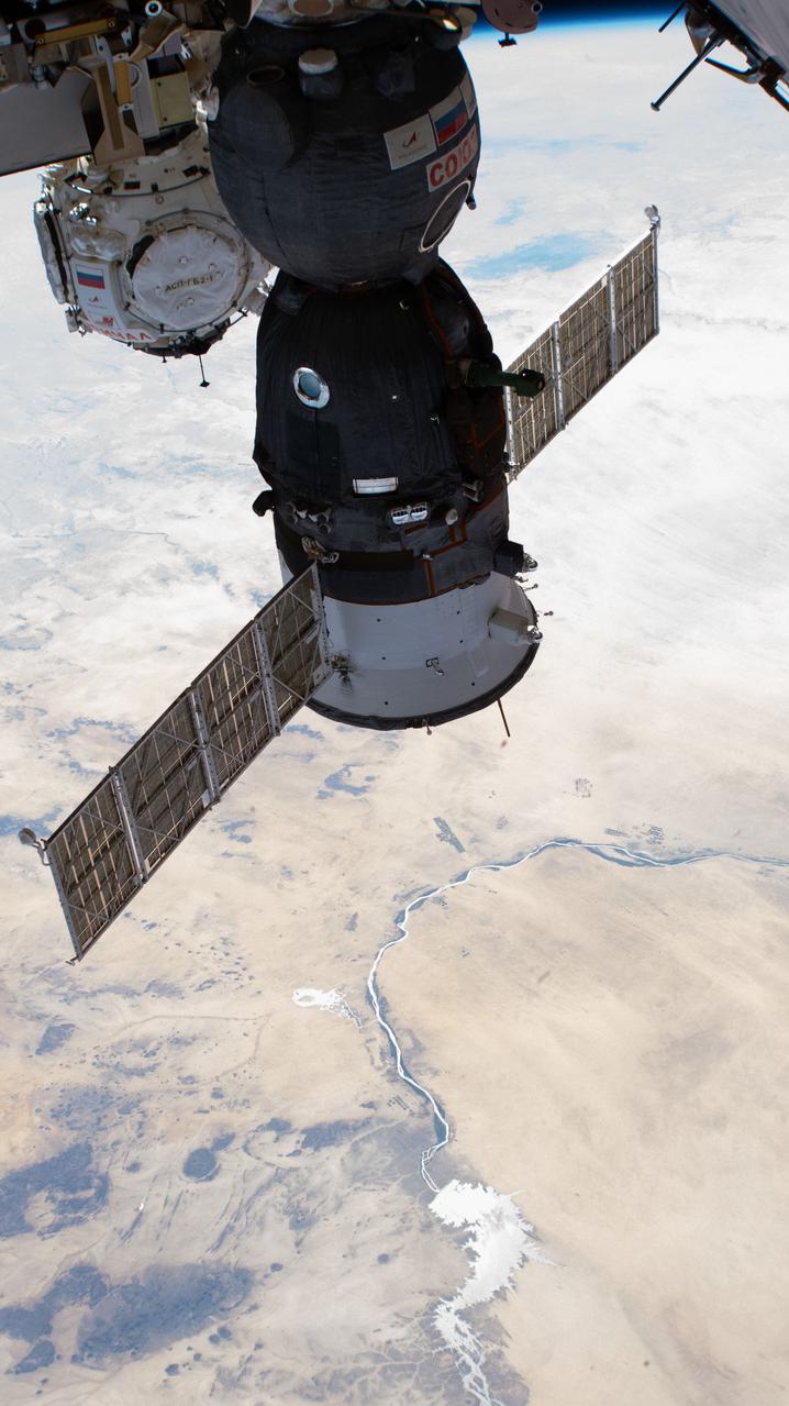 iss066e125408 (Jan. 24, 2022) --- The Soyuz MS-19 crew ship and the Prichal docking module (in the background), with the river Nile and the Menowe Reservoir below, are pictured as the International Space Station orbited 258 miles above the African nation of Sudan.