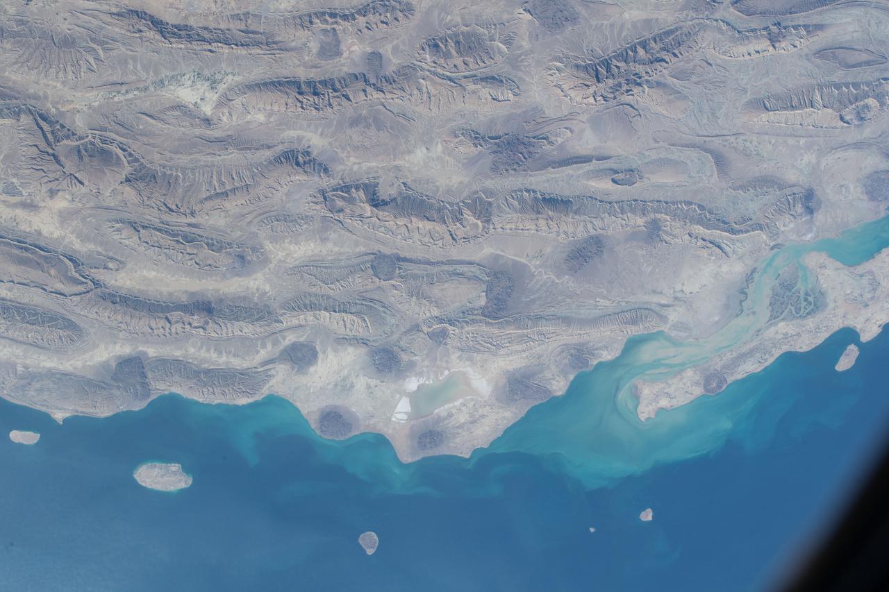 iss066e126129 (Jan. 26, 2022) --- The semi-desert, southern coast of Iran on the Persian Gulf is pictured from the International Space Station as it orbited 258 miles above the Middle Eastern nation.