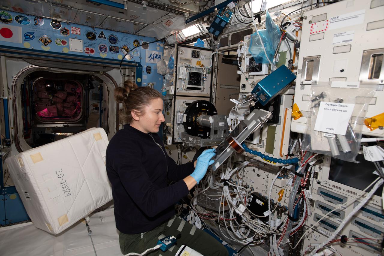 iss066e133963 (Feb. 2, 2022) --- NASA astronaut and Expedition 66 Flight Engineer Kayla Barron works inside the Kibo laboratory module cleaning the Cell Biology Experiment Facility, an incubator with an artificial gravity generator.