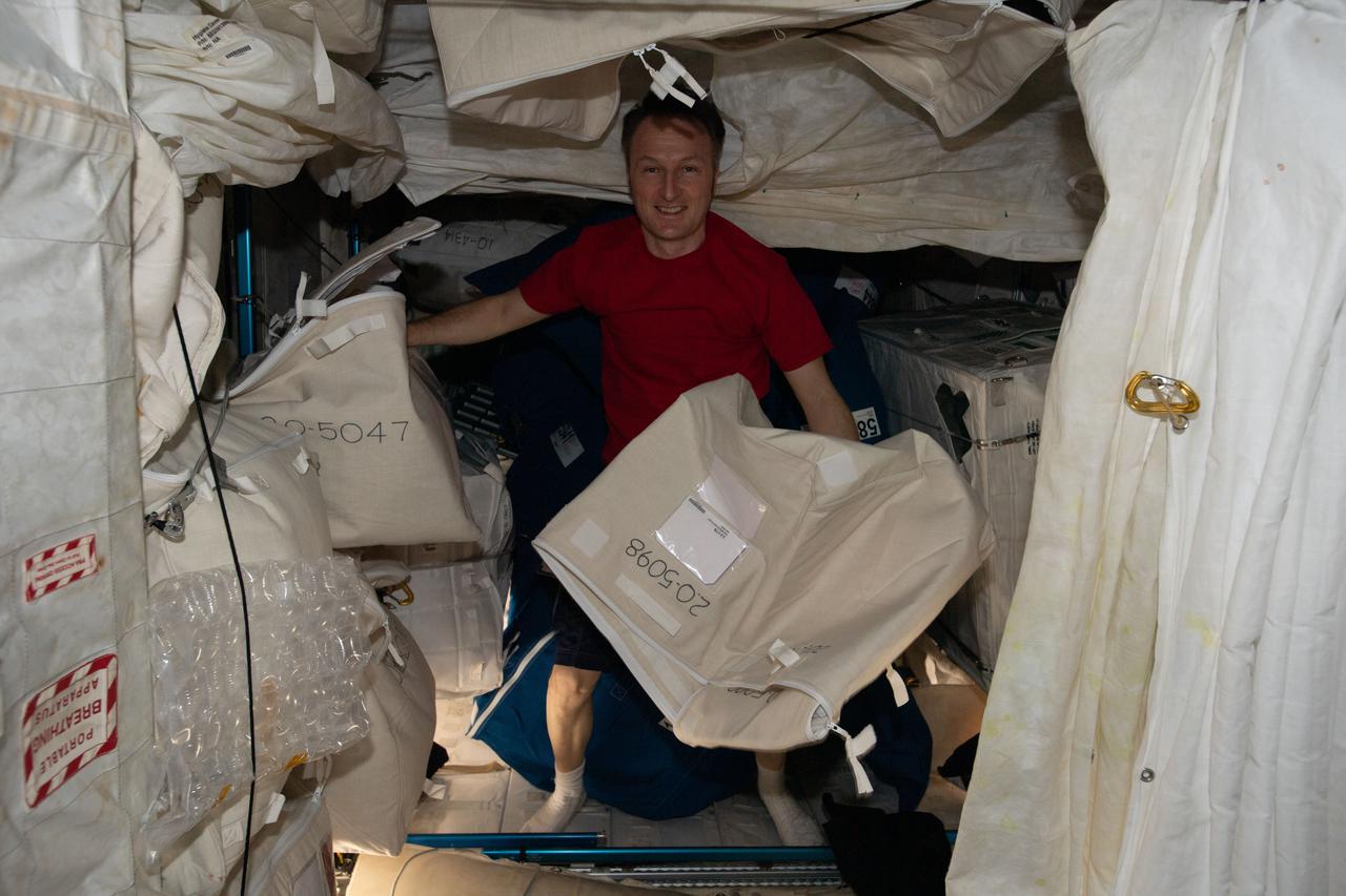 iss066e137876 (Feb. 8, 2022) --- ESA (European Space Agency) astronaut and Expedition 66 Flight Engineer Matthias Maurer organizes cargo inside the Leonardo permanent multipurpose module.