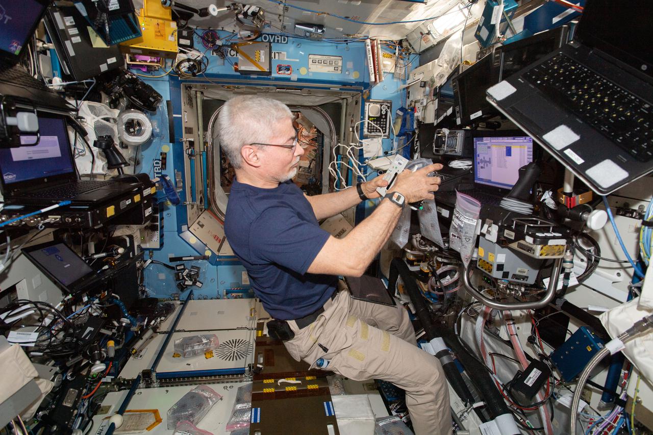 iss066e137924 (Feb. 9, 2022) --- NASA astronaut and Expedition 66 Flight Engineer Mark Vande Hei services components inside the Multi-use Variable-G Platform, a biology research device that can generate up to 2G of artfifical gravity.