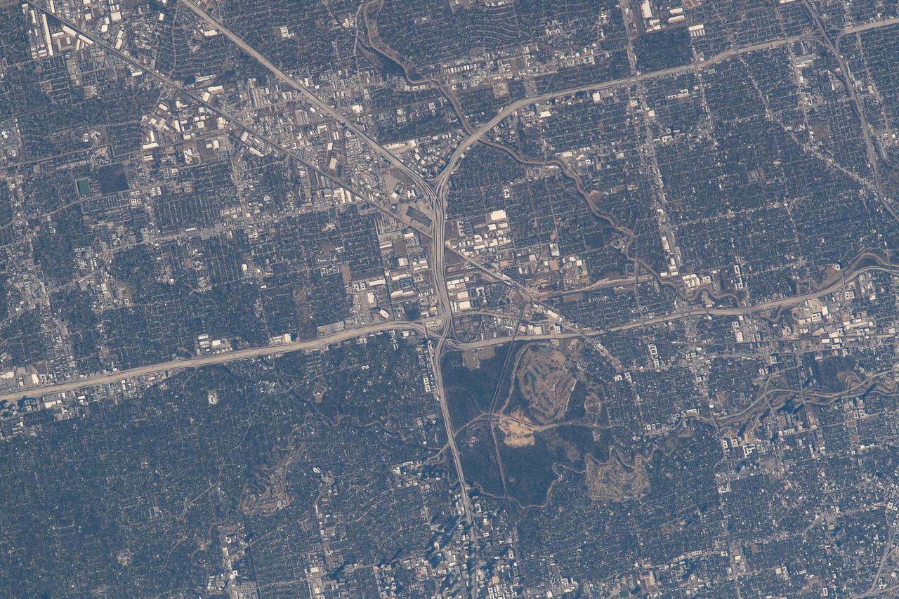 iss066e143699 (Feb. 13, 2022) --- The northwest corner of Houston, Texas, with the major highways of Interstate 610 looping around the city, Interstate 10 moving east to west, and U.S. 290 heading northwest, are pictured from the International Space Station as it orbited 258 miles above the Lone Star state.