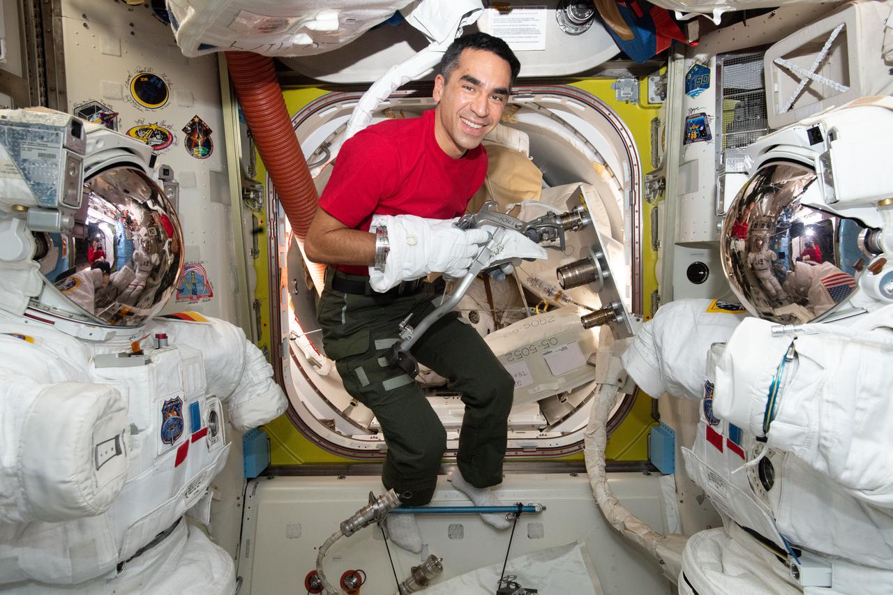iss066e146485 (Feb. 19, 2022) --- NASA astronaut and Expedition 66 Flight Engineer Raja Chari tests using tools while wearing a spacesuit glove inside the International Space Station's U.S. Quest airlock.