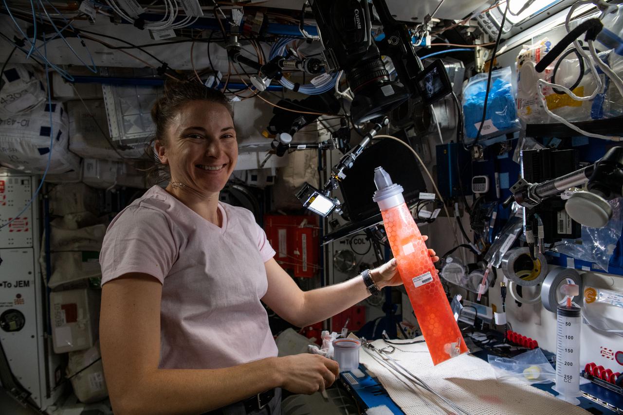 iss066e155768 (March 1, 2022) --- NASA astronaut and Expedition 66 Flight Engineer Kayla Barron works on an orbital plumbing demonstration in the Harmony module observing fill and drain cycles on two different Collapsible Contingency Urinal designs.