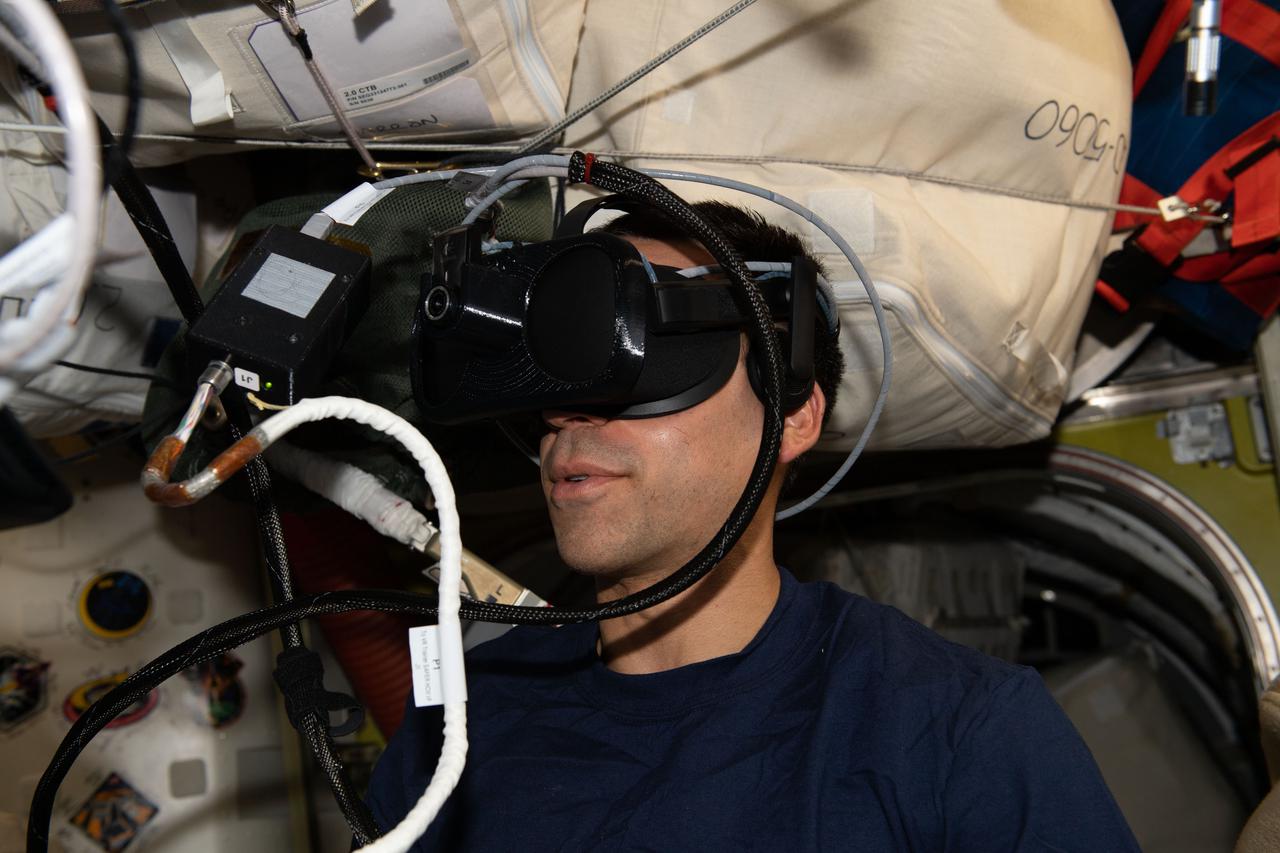iss066e156067 (March 2, 2022) --- NASA astronaut and Expediiton 66 Flight Engineer Raja Chari wears virtual reality goggles to practice spacewalk rescue scenarios that would be used while maneuvering using the U.S. spacesuit's SAFER jet pack, also known as Simplified Aid For EVA Rescue.