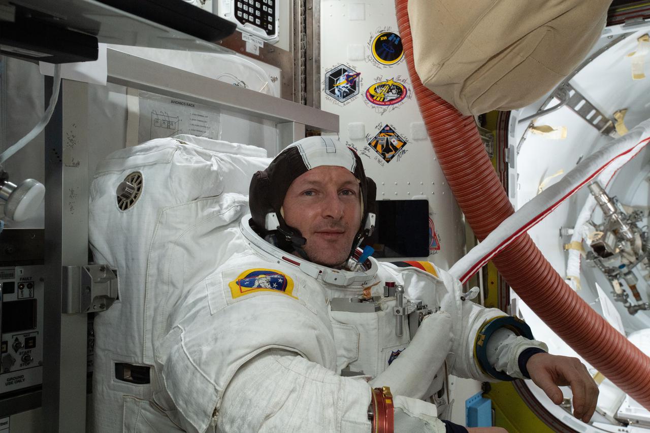 iss066e157107 (March 4, 2022) --- ESA (European Space Agency) astronaut and Expedition 66 Flight Engineer Matthias Maurer conducts a fit check of his U.S. spacesuit inside the International Space Station's Quest airlock.