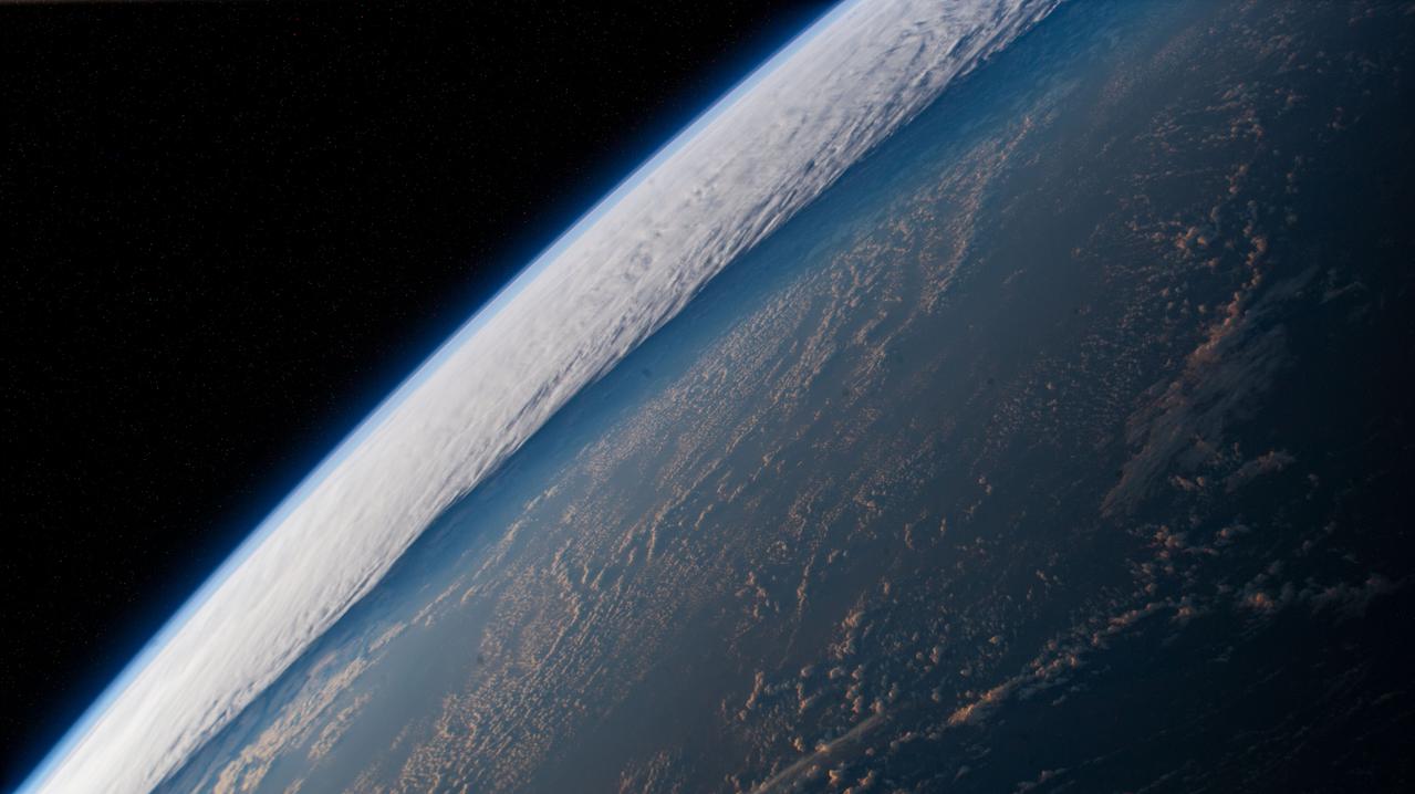 iss066e161043 (March 10, 2022) --- The International Space Station orbits into a dawn 261 miles above a cloudy Pacific Ocean.