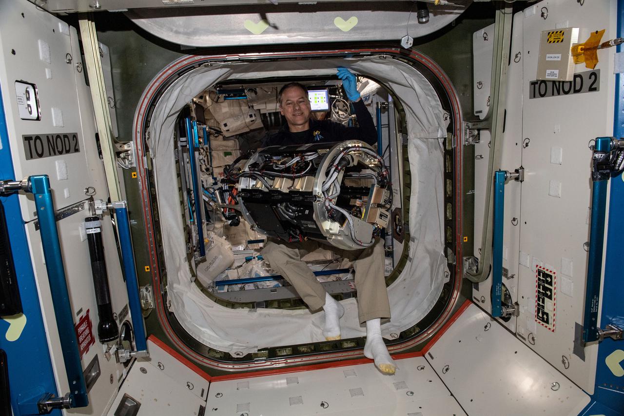 iss066e161281 (March 11, 2022) --- NASA astronaut and Expedition 66 Flight Engineer Tom Marshburn carries the Combustion Chamber, the main component of the Combution Integrated Rack, to prepare the research device for a fire safety experiment aboard the International Space Station.