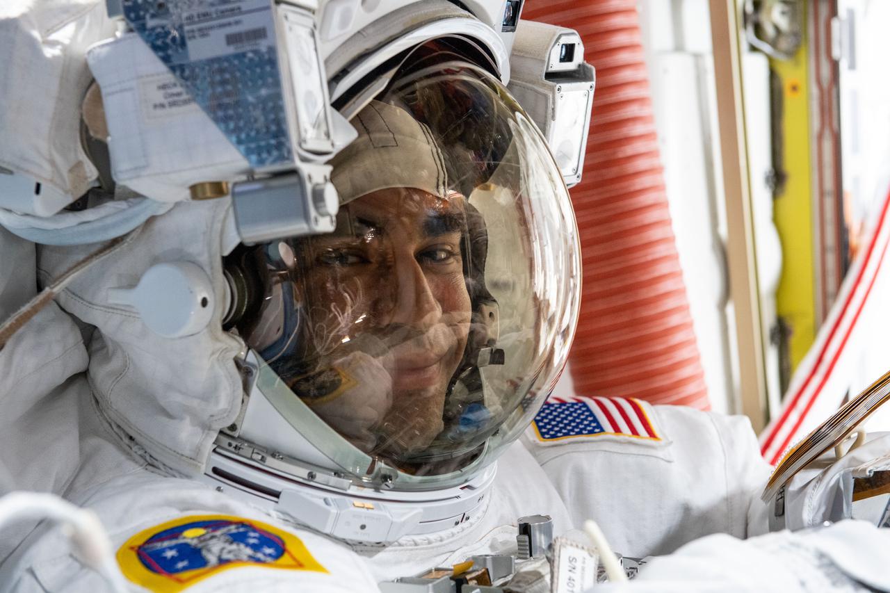 iss066e163010 (March 15, 2022) --- NASA astronaut Raja Chari is pictured inside the U.S. Quest airlock suited up and preparing for a six-hour and 54-minute spacewalk to set up the International Space Station for its next roll-out solar array.