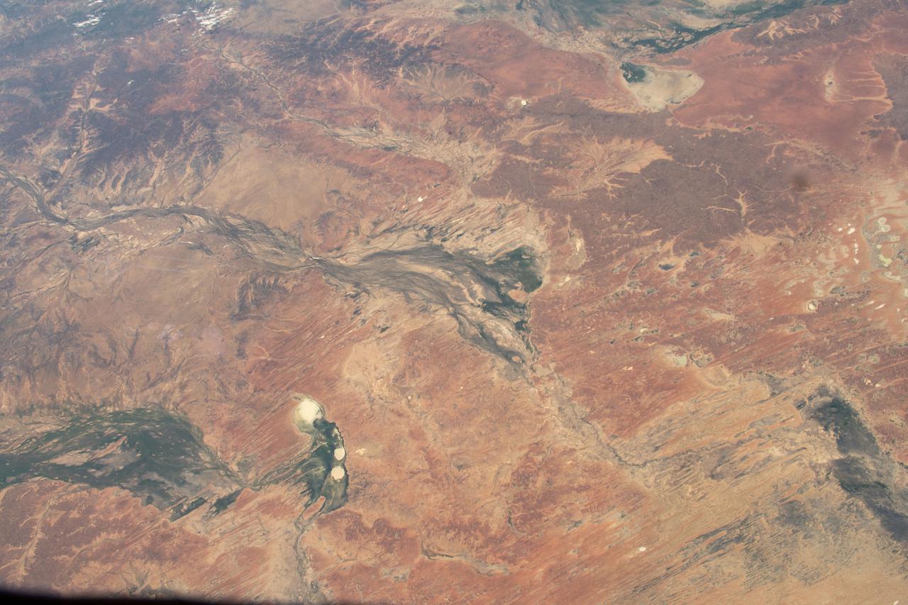iss066e163491 (March 11, 2022) --- The remote region of Central West Queensland in Australia is pictured from the International Space Station as it orbited 262 miles above. Notable geographical features pictured include the Diamantina River, flowing from upper left to lower right, and Lake Machattie at lower center left.