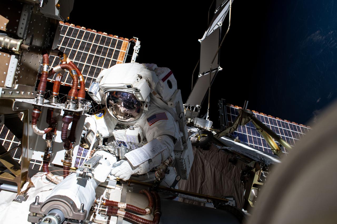 iss066e166221 (March 15, 2022) --- NASA astronaut Kayla Barron is pictured installing a modification kit on the International Space Station's Port-4 truss segment during a six-hour and 54-minute spacewalk setting it up for its next roll-out solar array.