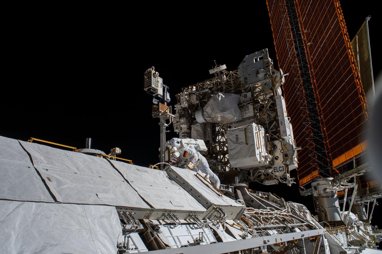 iss066e174193 (March 23, 2022) ---  Astronaut Matthias Maurer of ESA (European Space Agency) is pictured on the International Space Station's truss structure during a spacewalk to install thermal gear and electronics components on the orbiting lab.