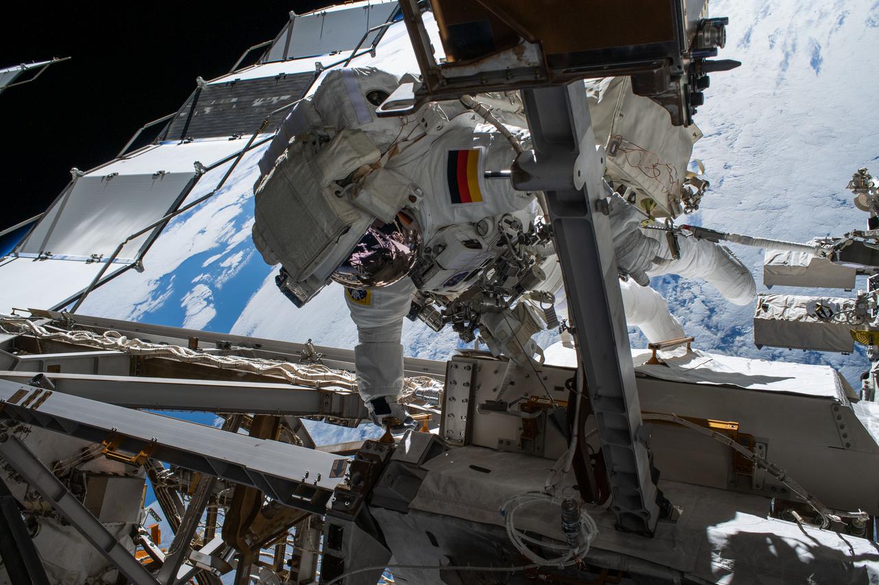 iss066e174286 (March 23, 2022) --- Astronaut Matthias Maurer of ESA (European Space Agency) is pictured on the International Space Station's truss structure during a spacewalk to install thermal gear and electronics components on the orbiting lab.