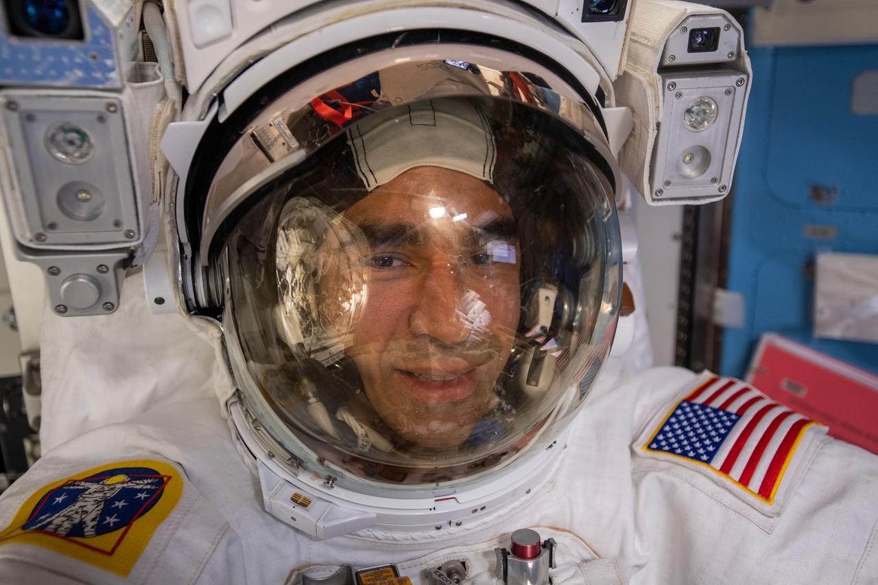 iss066e174346 (March 23, 2022) --- NASA astronaut and Expediution 66 Flight Engineer Raja Chari is pictured in his U.S. spacesuit prior to beginning a spacewalk to install thermal gear and electronics components on the International Space Station.