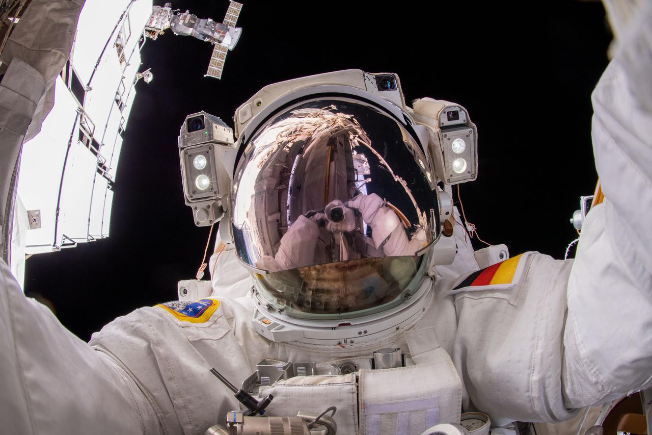 iss066e175249 (March 23, 2022) --- ESA (European Space Agency) astronaut and Expedition 66 Flight Engineer Matthias Maurer points the camera toward himself and takes a "space-selfie" during a six-hour and 54-minute spacewalk to install thermal gear and electronic components on the International Space Station.
