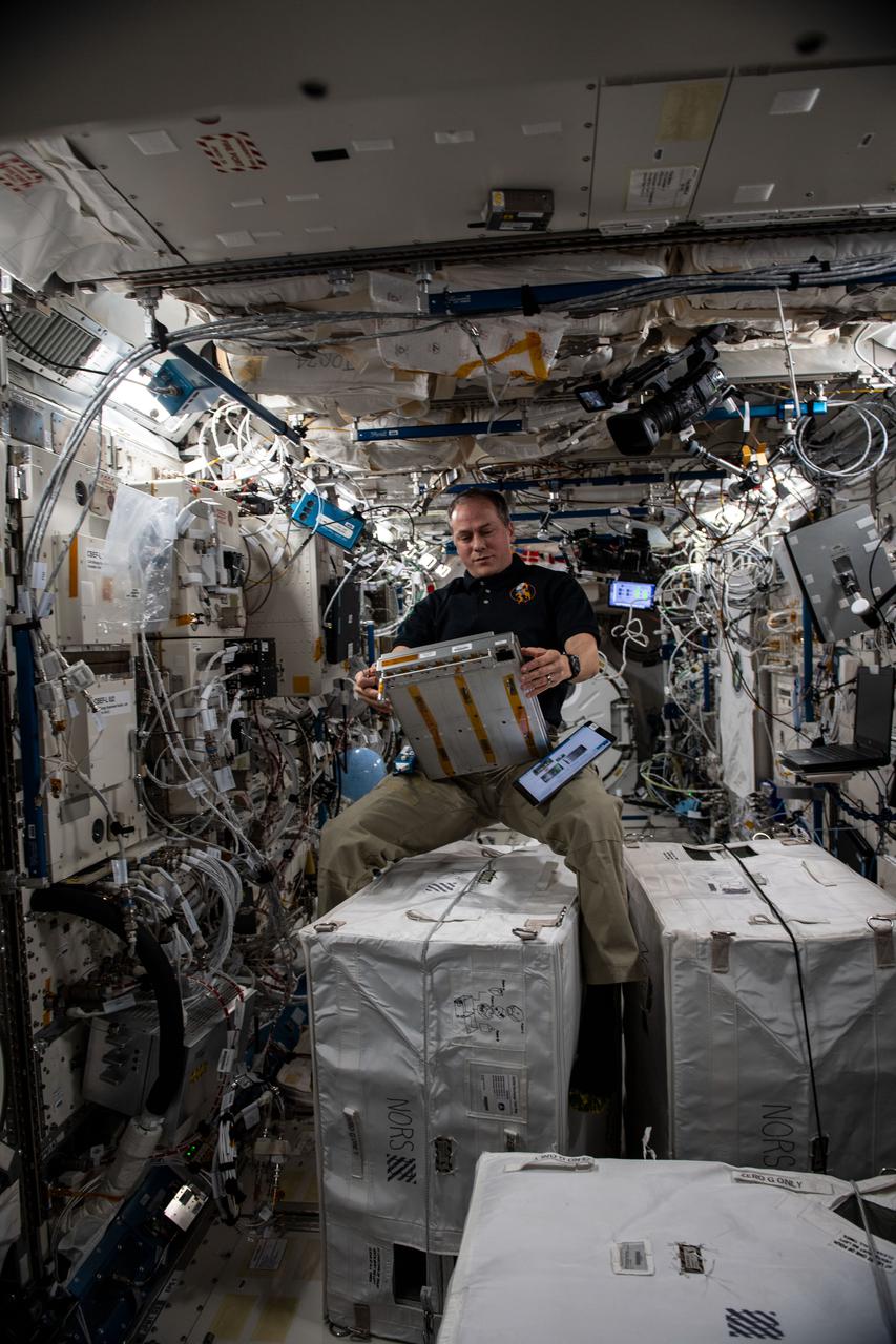 iss066e179239 (March 25, 2022) --- NASA astronaut and Expedition 66 Flight Engineer Tom Marshburn services components on a unique incubator that can generate artificial gravity inside the Kibo laboratory module's Cell Biology Experiment Facility.
