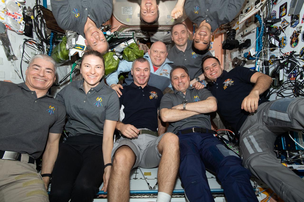 iss066e186031 (March 30, 2022) --- The ten-member Expedition 66 crew poses for a portrait aboard the International Space Station. In the front row, from left, are NASA astronauts Mark Vande Hei and Kayla Barron; and Roscosmos cosmonauts Denis Matveev, Anton Shkalperov, and Sergey Korsakov. In the back, from left, are NASA astronaut Tom Marshburn; ESA (European Space Agency) astronaut Matthias Maurer; Roscosmos cosmonauts Oleg Artemyev and Pyotr Dubrov; and NASA astronaut Raja Chari.