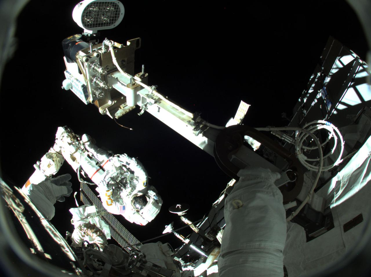 iss066e188275 (March 23, 20222) --- NASA astronaut and Expedition 66 Flight Engineer Raja Chari is pictured attached to the Canadarm2 robotic arm during a six-hour and 54-minute spacewalk to install thermal gear and electronic components on the International Space Station.