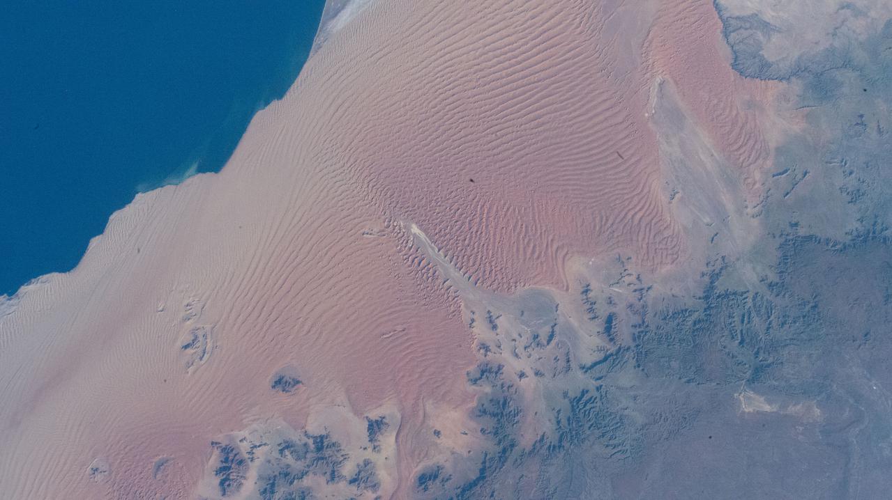 iss067e003783 (April 6, 2022) --- The Namib Desert is pictured from the International Space Station as it orbited 262 miles above the Atlantic Ocean just off the coast of the African nation of Namibia.