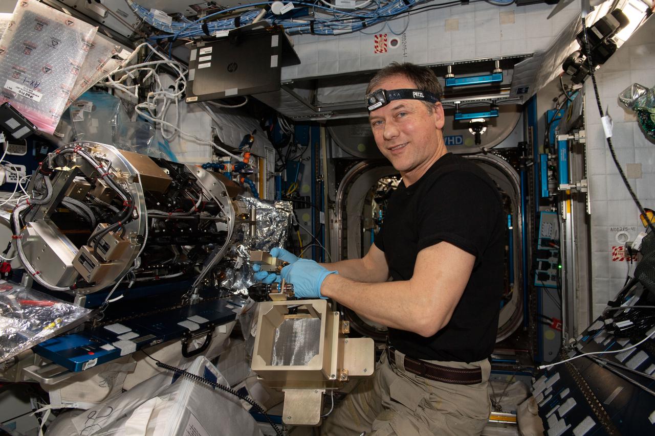 iss067e003872 (April 6, 2022) --- NASA astronaut and Expedition 67 Commander Thomas Marshburn configures the Combustion Integrated Rack's combustion chamber for the Solid Fuel Ignition and Extinction study to investigate material flammability and ways to improve fire safety in space.