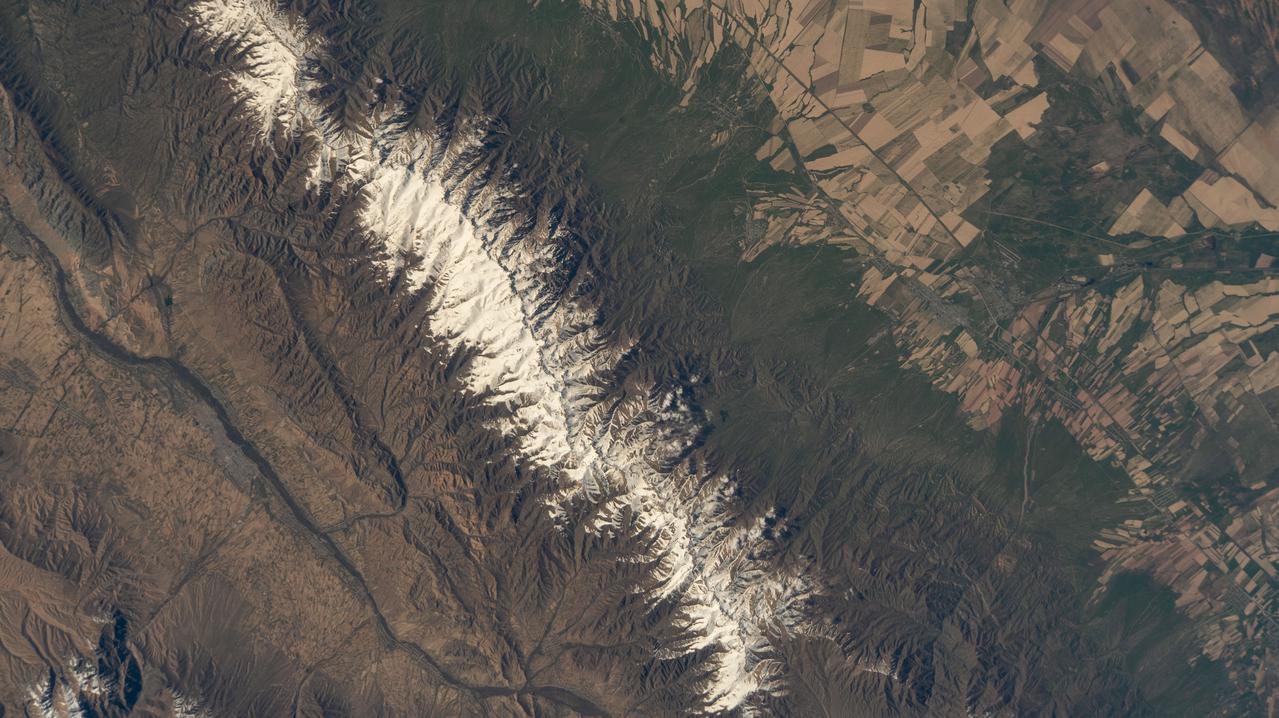 iss067e014096 (April 15, 2022) --- The mountainous border region between Kazakhstan and Kyrgyzstan is pictured from the International Space Station as it orbited 262 miles above Centtral Asia.