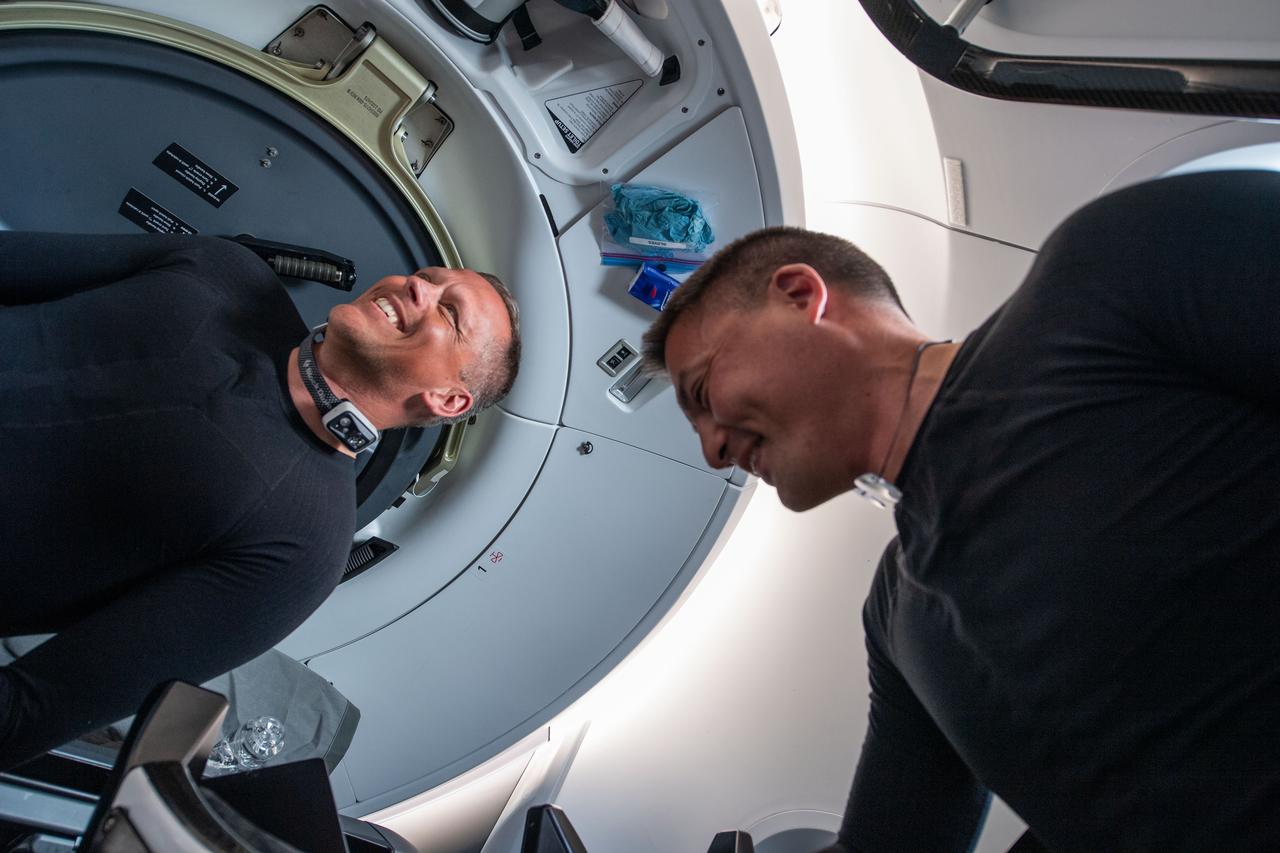 iss067e034516 (April 27, 2022) --- NASA astronauts (from left) Bob Hines and Kjell Lindgren, Crew-4 Pilot and Commander, respectively, are pictured inside the SpaceX Dragon Freedom spacecraft during their journey to the International Space Station.