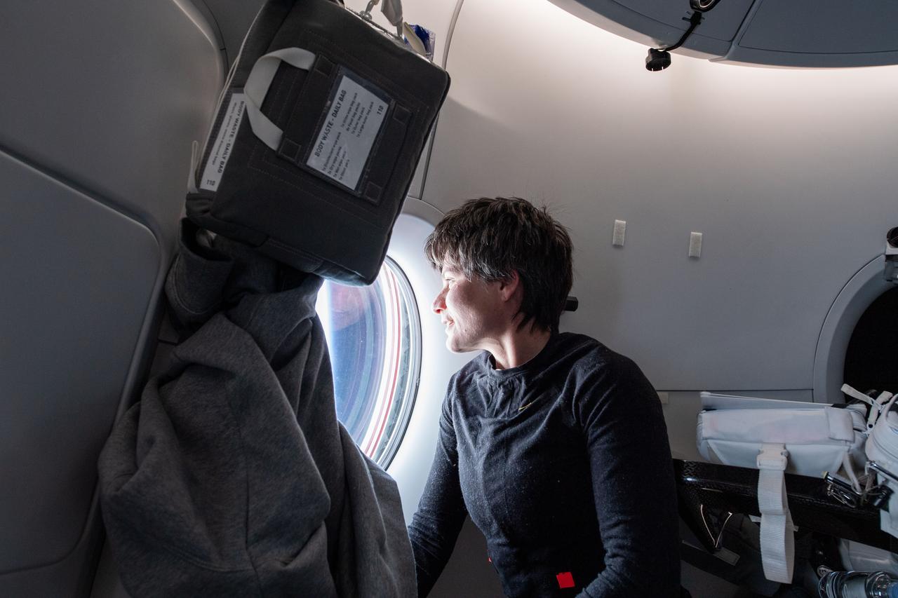 iss067e034536 (April 27, 2022) --- ESA (European Space Agency) astronaut Samantha Cristoforetti, Crew-4 Mission Specialist, is pictured looking out the SpaceX Dragon Freedom spacecraft’s windows during her journey to the International Space Station.