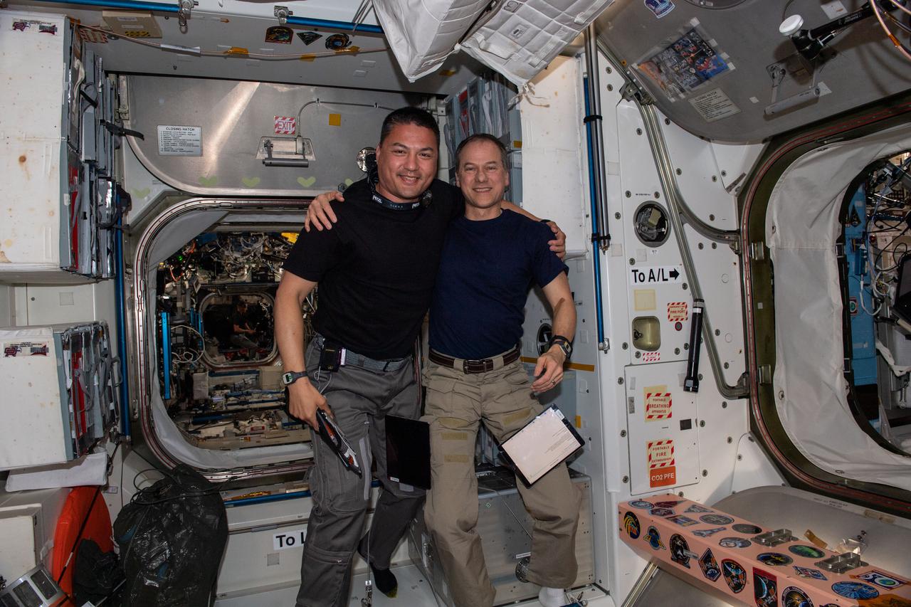iss067e034662 (May 5, 2022) --- Expedition 67 Flight Engineers from NASA (from left) Kjell Lindgren and Tom Marshburn pose for a portrait inside the International Space Station's Unity module.