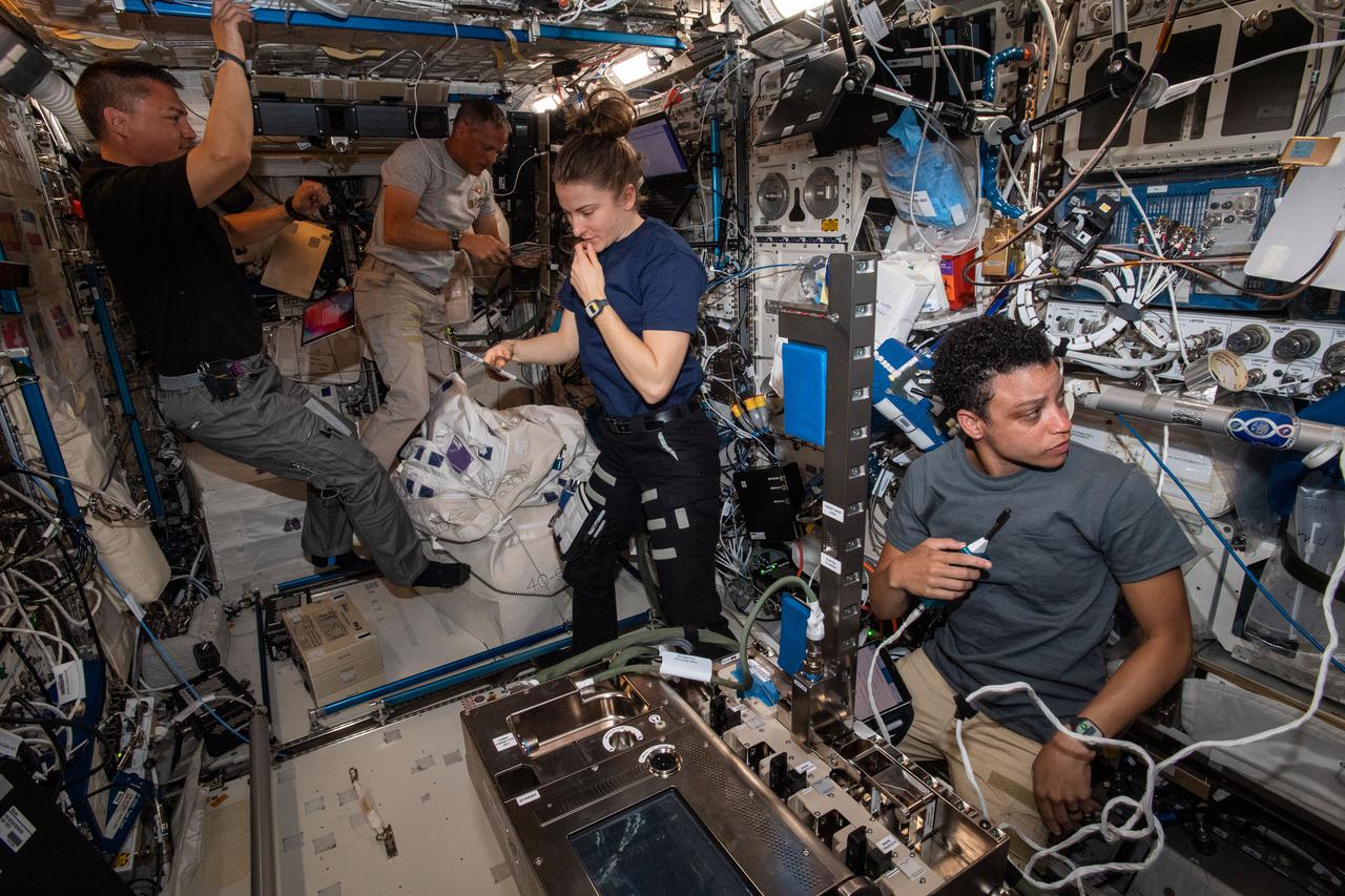 iss067e034980 (May 2, 2022) --- Expedition 67 Flight Engineers from NASA (from left) Kjell Lindgren, Bob Hines, Kayla Barron, and Jessica Watkins participate in a variety of activities inside the International Space Station's Columbus laboratory module.
