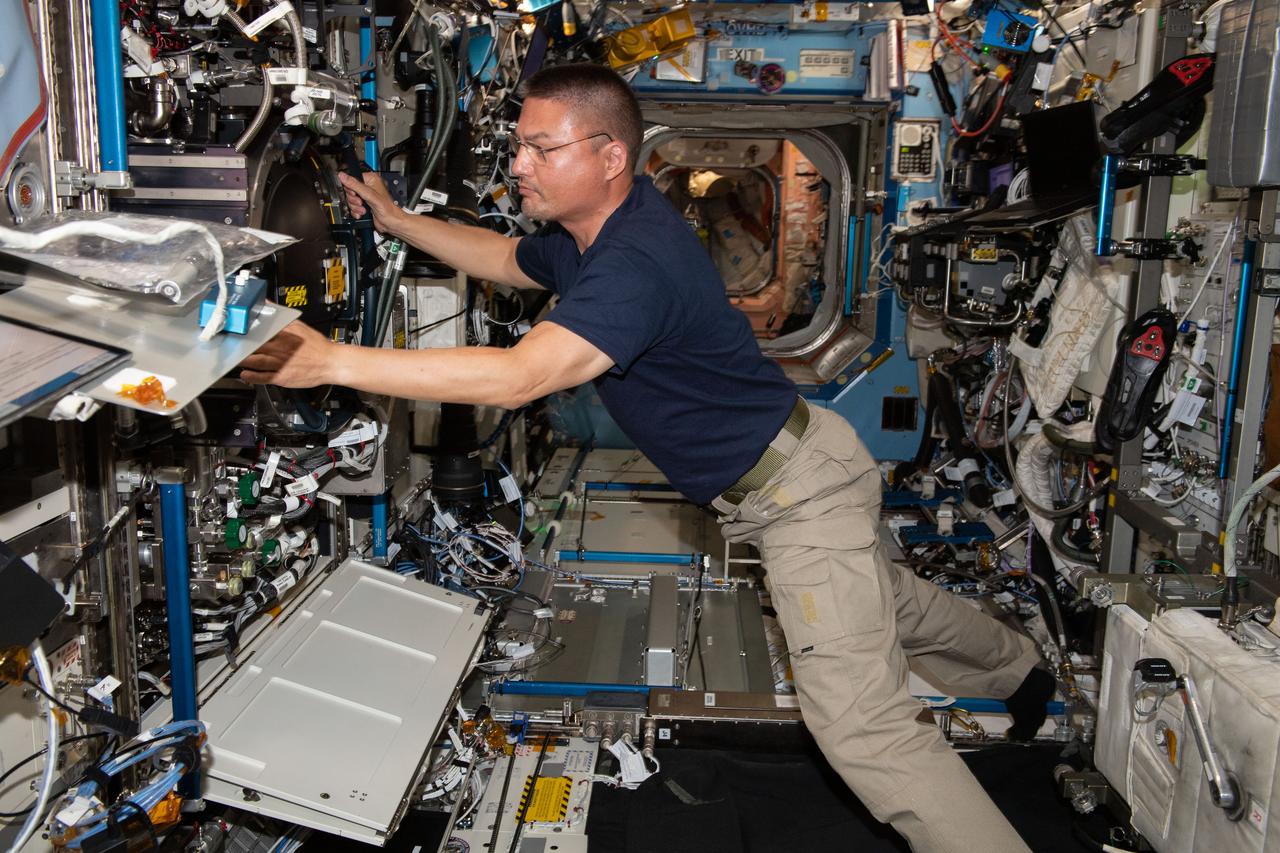 iss067e044198 (May 16, 2022) --- NASA astronaut and Expedition 67 Flight Engineer Kjell Lindgren checks filter, hose, and gas connections inside the International Space Station's Combustion Integrated Rack, a research device that enables safe investigations into how flames, fiuel, and soot behave in microgravity.