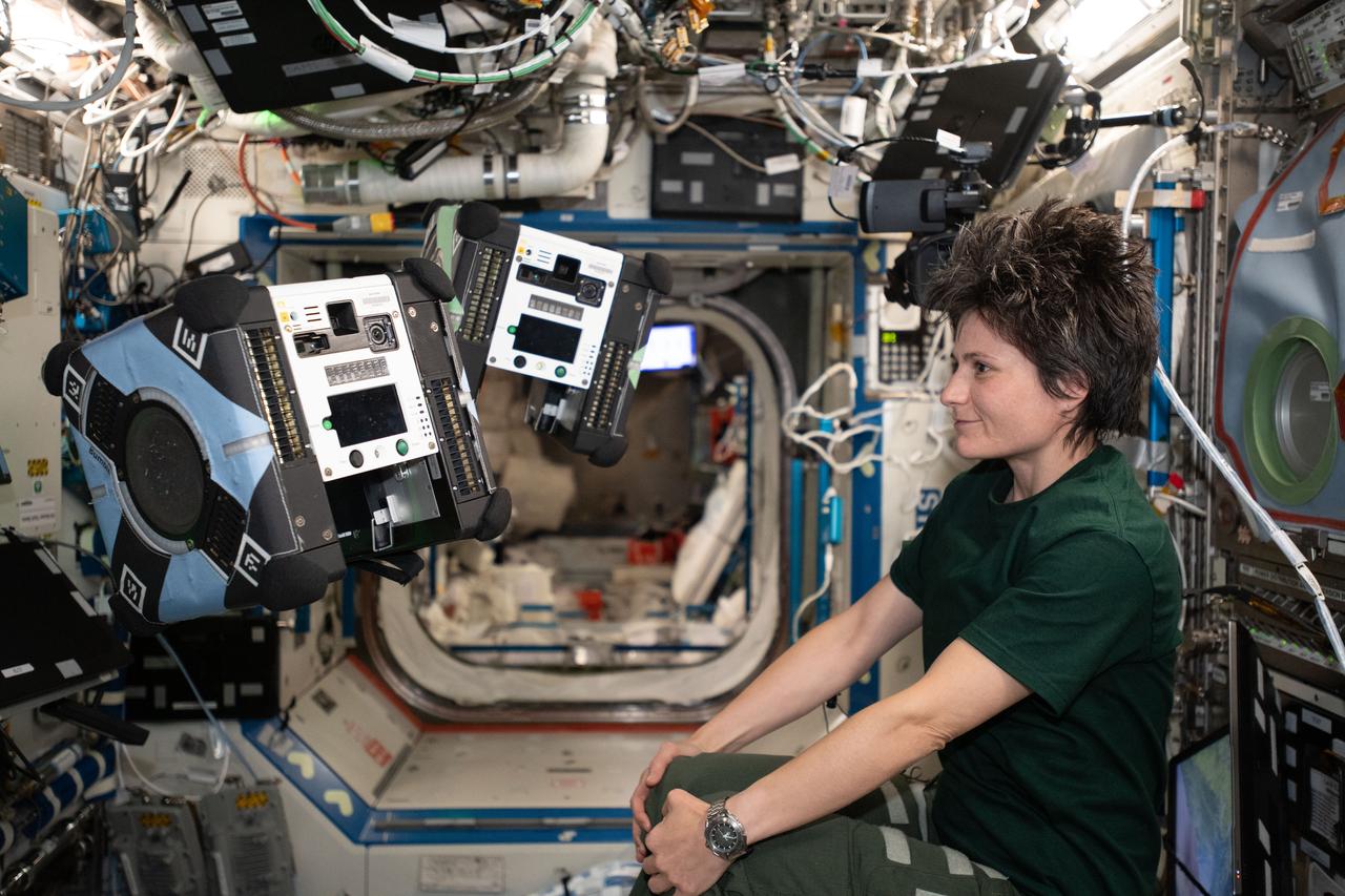 iss067e059518 (May 18, 2022) --- ESA (European Space Agency) astronaut and Expedition 67 Flight Engineer Samantha Cristoforetti monitors a pair of Astrobee robotic free-flyers performing autonomous maneuvers inside the International Space Station. The cube-shaped, toaster-sized robots are designed to help scientists and engineers develop and test technologies for use in microgravity to assist astronauts with routine chores, and give ground controllers additional eyes and ears on the space station.