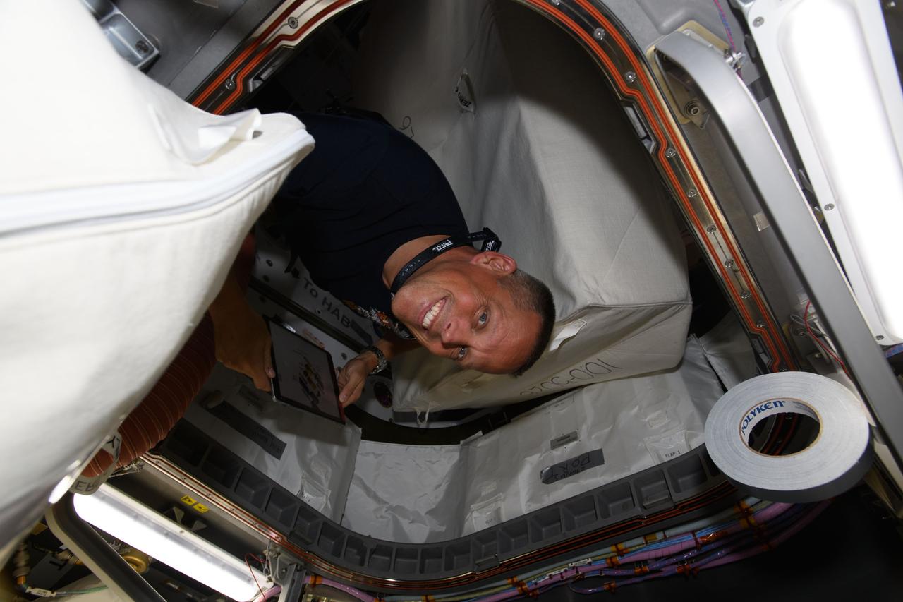 iss067e065290 (May 19, 2022) --- NASA astronaut and Expedition 67 Flight Engineer Bob Hines is pictured inside the vestibule between the International Space Station's Unity module and the U.S. Cygnus space freighter from Northrop Grumman.