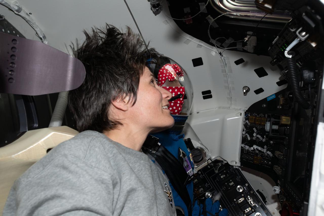 iss067e065447 (May 21, 2022) --- ESA (European Space Agency) astronaut Samantha Cristoforetti is seated next to "Rosie the Rocketeer" inside Boeing's CST-100 Starliner spacecraft the day after it had docked to the International Space Station's Harmony module on the company's Orbital Flight Test-2 mission.