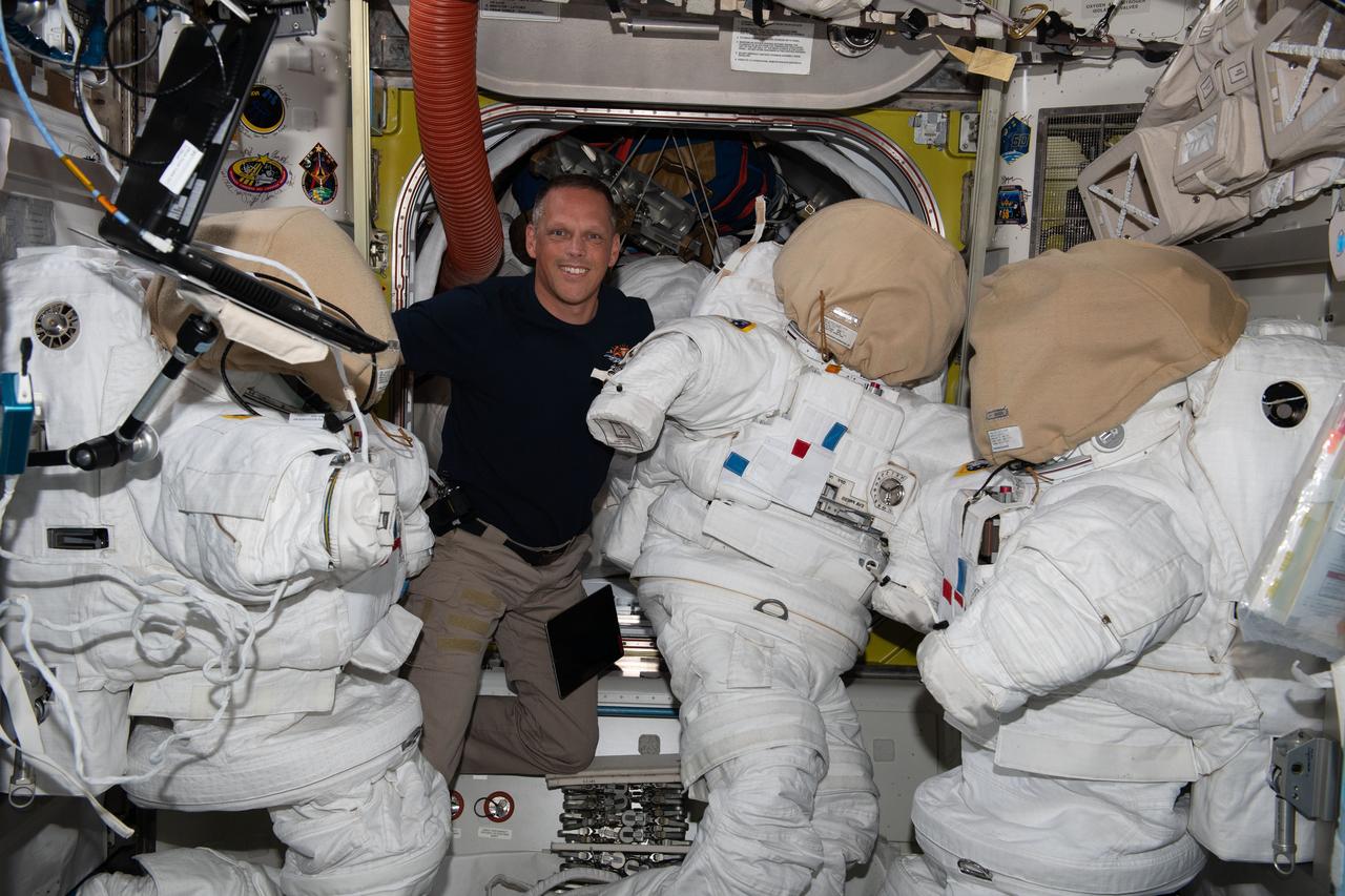 iss067e065514 (May 17, 2022) --- Expedition 67 Flight Engineer and NASA astronaut Bob Hines works on U.S. spacesuits inside the International Space Station's Quest airlock.