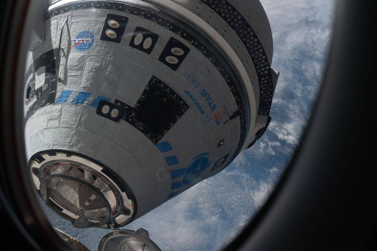 iss067e065888 (May 20, 2022) --- This view from a window on the SpaceX Crew Dragon Freedom crew ship shows Boeing's CST-100 Starliner crew ship moments away from docking to the Harmony module's forward port on the International Space Station for the company's Orbital Flight Test-2 mission.