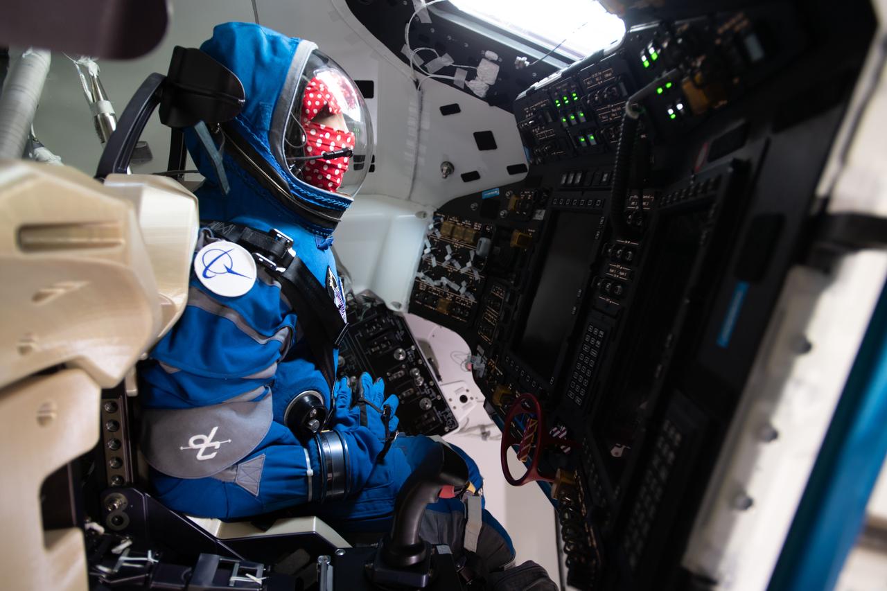 iss067e066358 (May 21, 2022) --- Rosie the Rocketeer, Boeing's anthropometric test device, is pictured in the commander's seat of the company's CST-100 Starliner crew ship for the Orbital Flight Test-2 mission at the International Space Station.