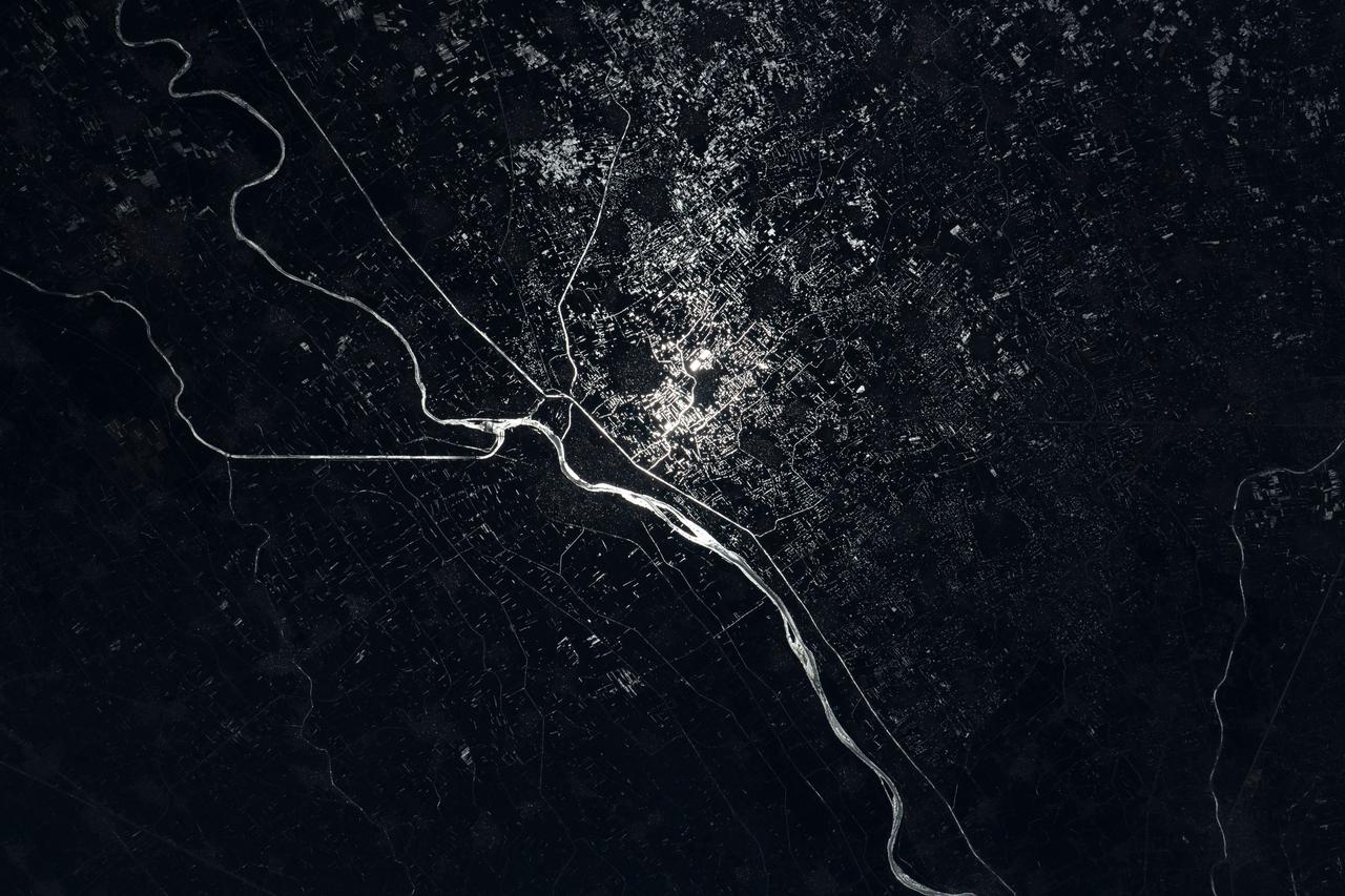 iss067e089285 (May 29, 2022) --- The Damietta Branch of the Nile River splits into canals in the central portion of the Nile Delta in Egypt. Lights from several cities surrounding the Egyptian waterways are pictured in this nighttime photograph from the International Space Station as it orbited 262 miles above the Mediterranean Sea off the coast of the Sinai Peninsula.