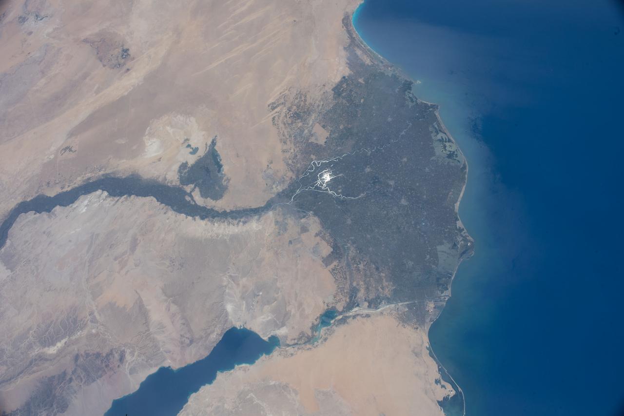 iss067e090312 (May 29, 2022) --- The Nile Delta is pictured from the International Space Station at an altitude of 262 miles above the Mediterranean Sea off the coast of Israel. The sun's glint beams off the Rosetta and the Damietta branches of the Nile River at the base of the Nile Delta.