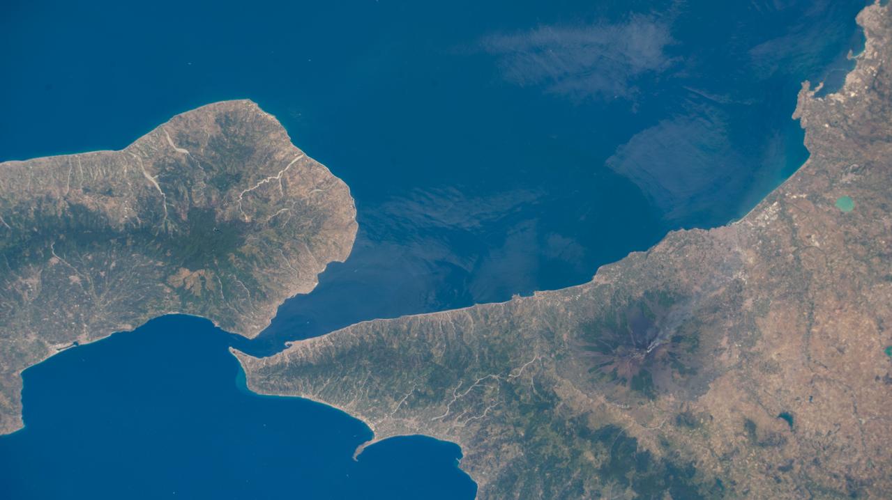 iss067e107087 (June 2, 2022) --- The southern tip of the boot of Italy (left) and the island of Sicily are pictured from the International Space Station as it orbited 262 miles above the Mediterranean Sea. Mount Etna (lower right), Europe's tallest active volcano on the coast of Sicily, is visible billowing with activity.